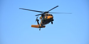 Askeri helikopter kolunu yem karma makinesine kaptıran besici için havalandı